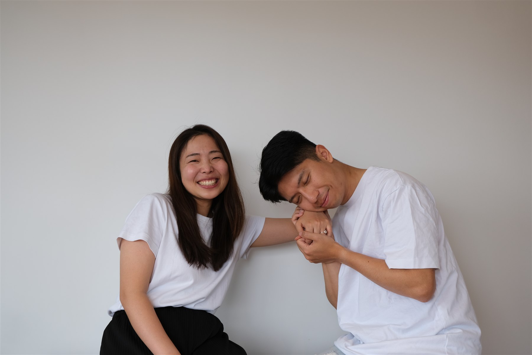 Shawn kissing Hitomi's hand as they laugh