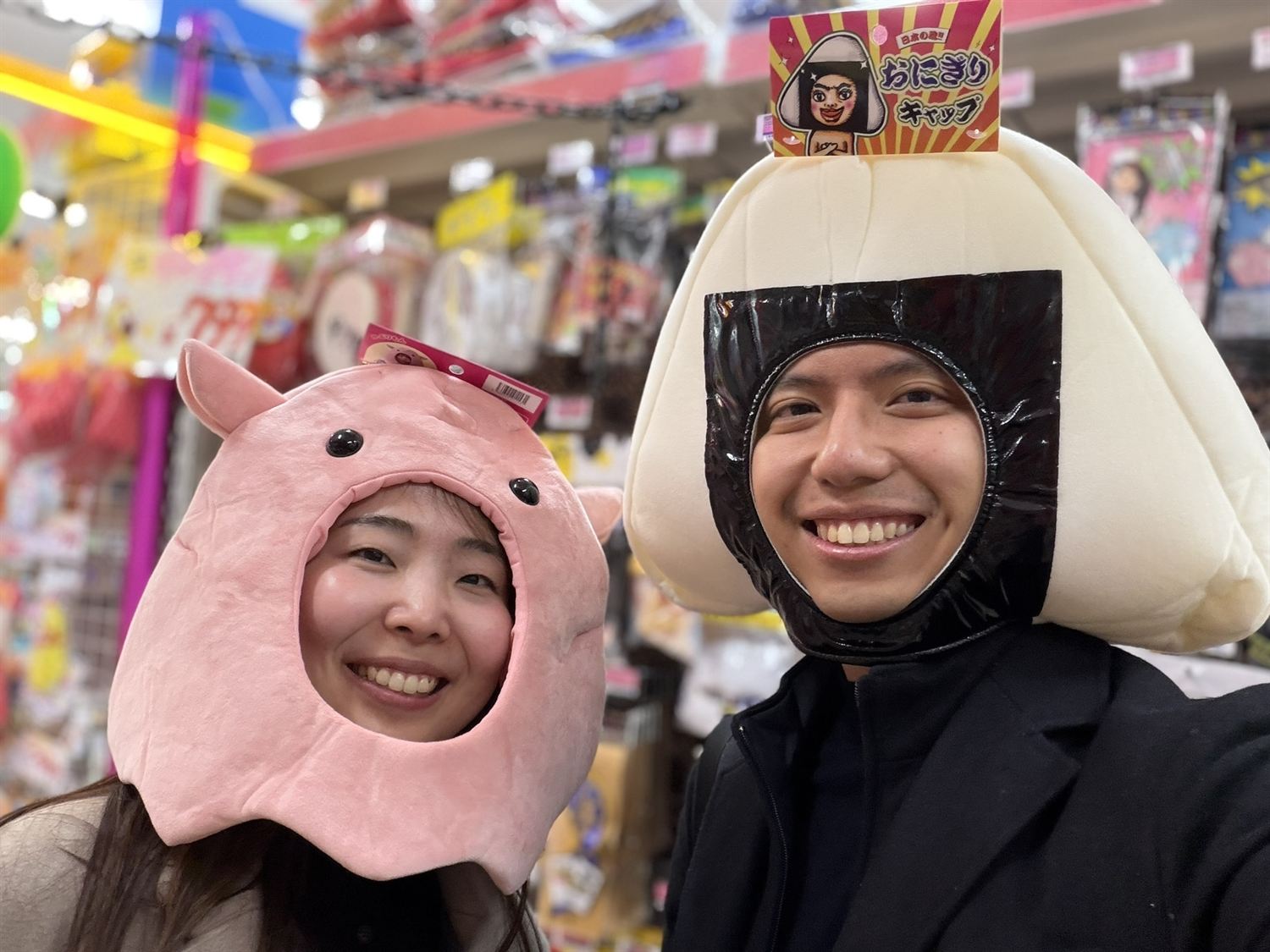 Shawn and Hitomi smiling while trying playful costumes in Japan